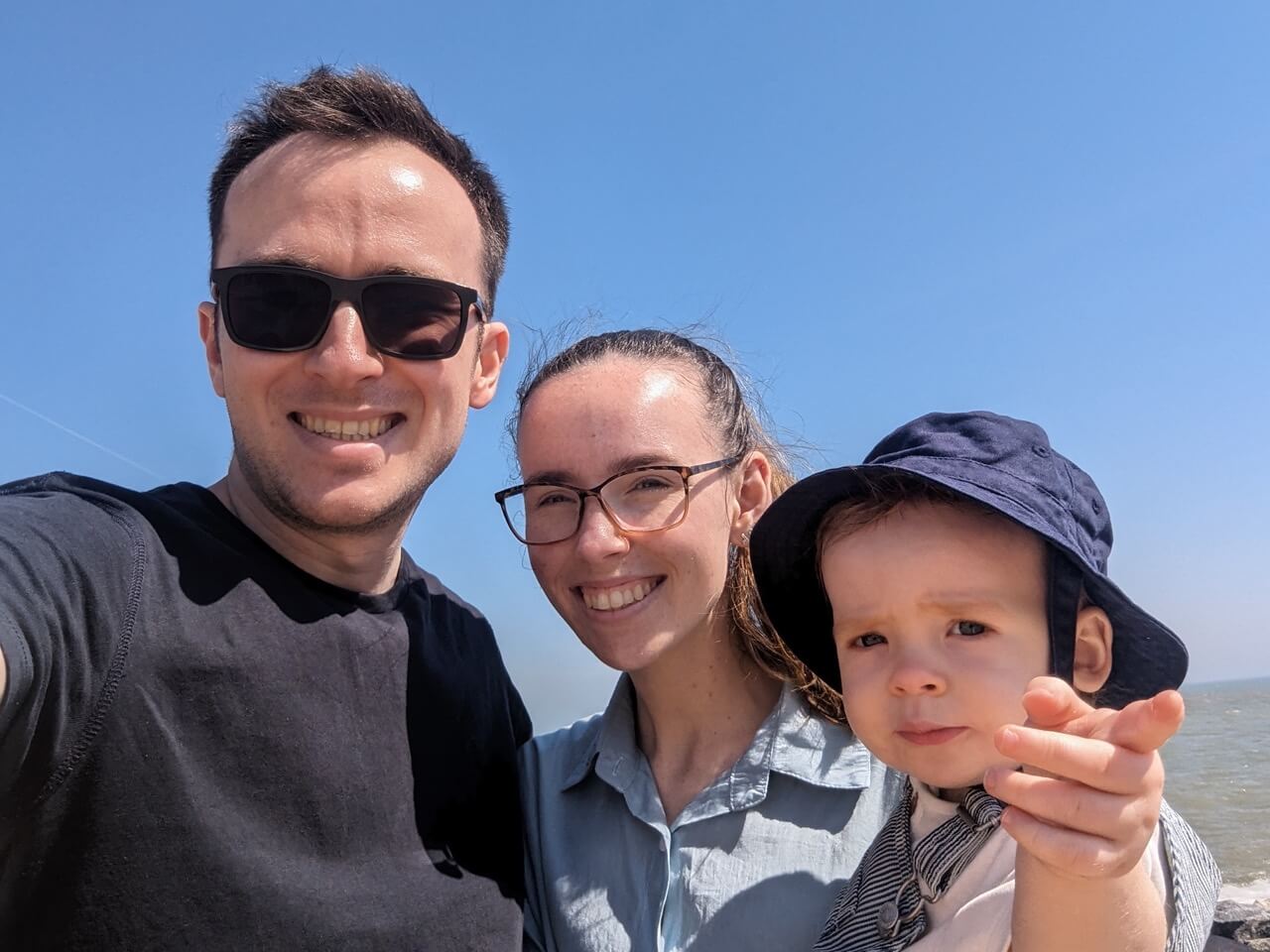 A selfie of my, my wife, and my son - we’re standing on the beach smiling at the camera