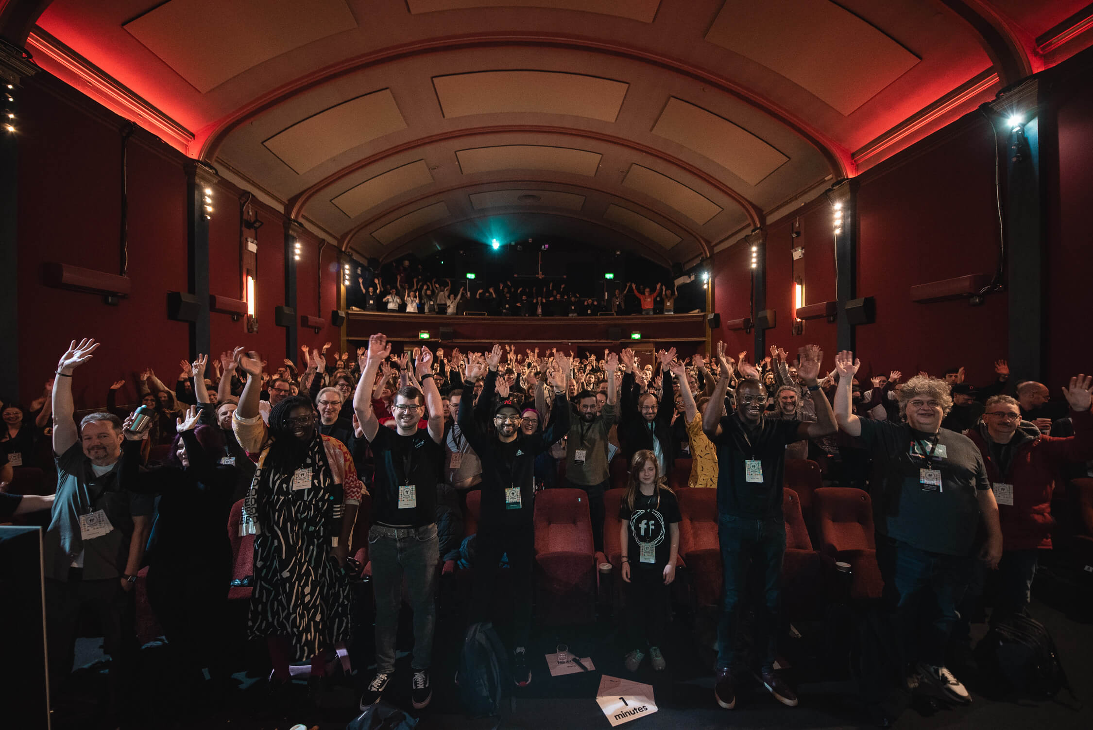 Looking out from the stage back towards the packed out crowd, with their hands raised and all smiling