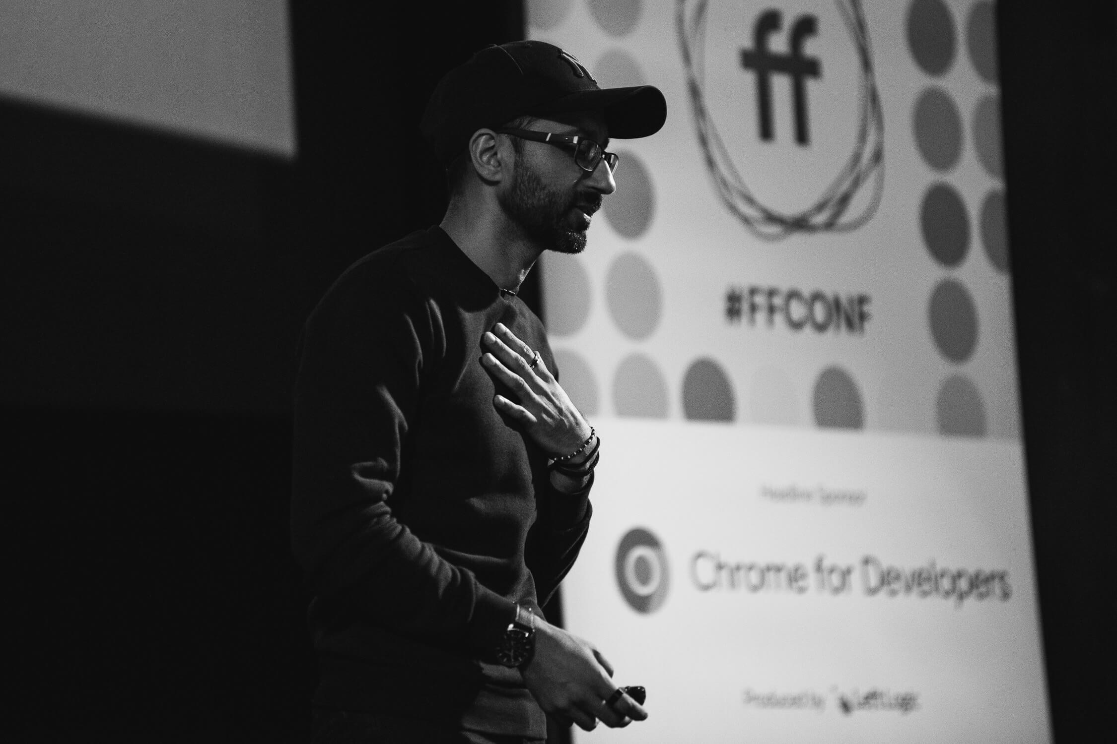 Imran Afzal presenting the final talk of the day on reflection, standing in front of a large FFConf banner